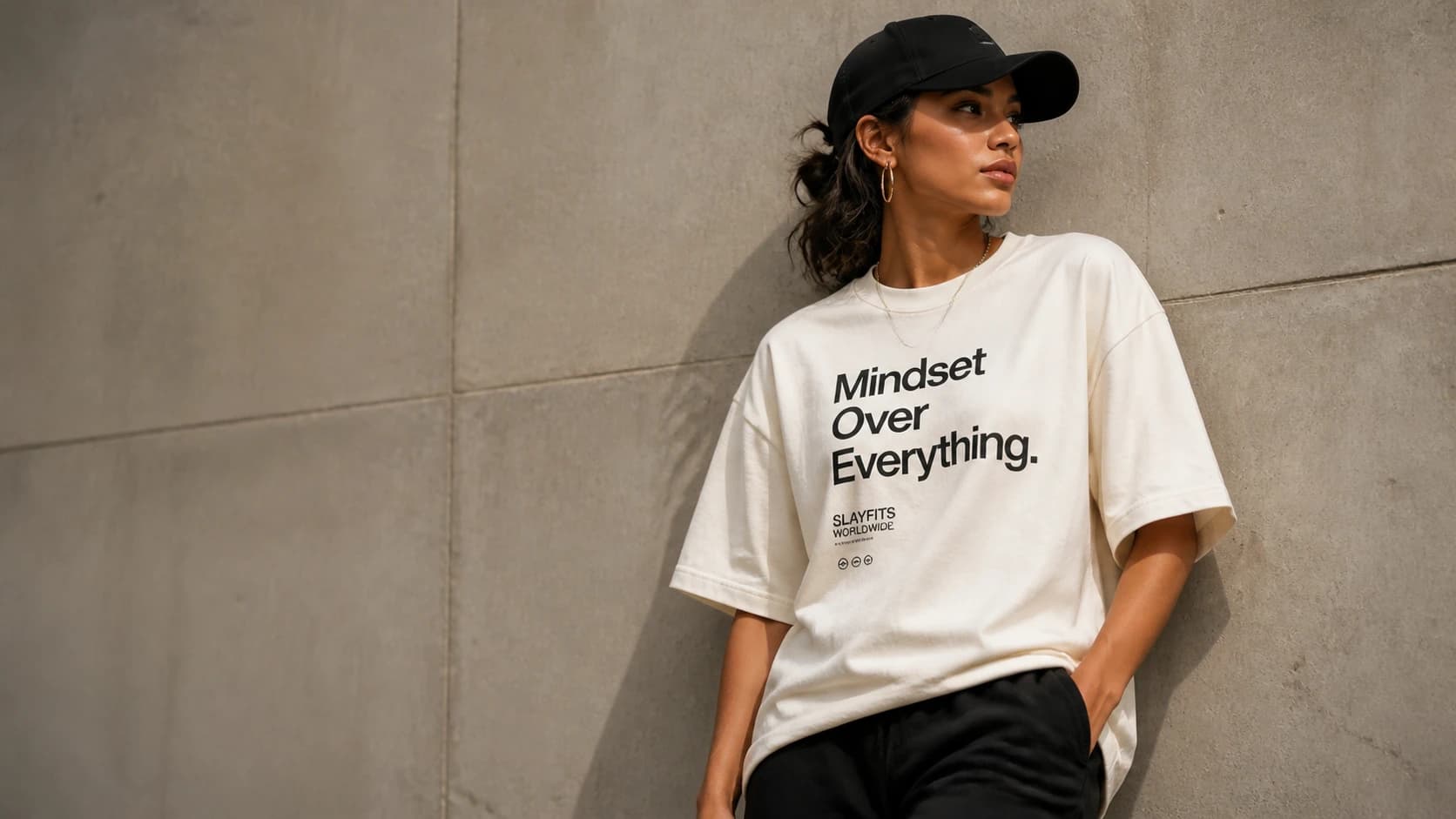 Model wearing a SLAYFITS tee in a relaxed, casual setting